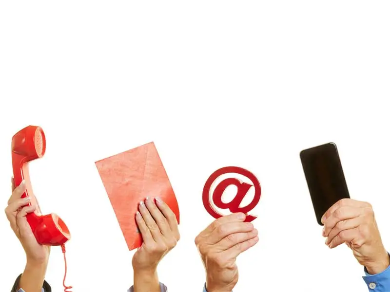 hands holding up a phone, letter, email and smartphone