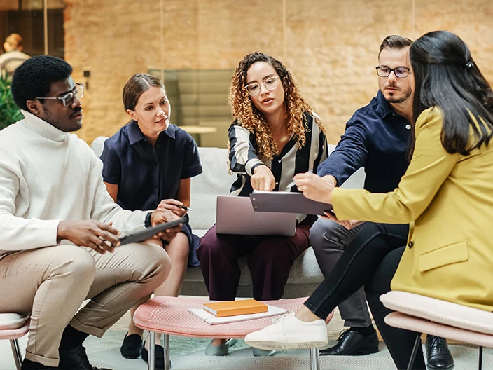 A group of customer experience professionals collaborating in an office.