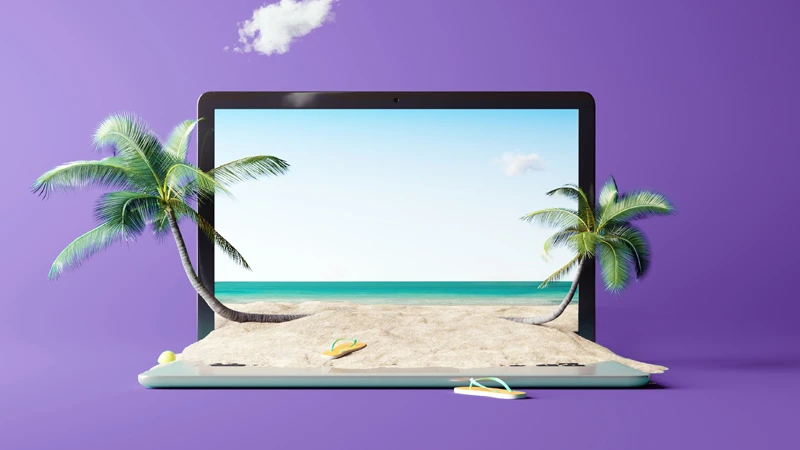 Laptop screen with a tropical beach spilling out of it