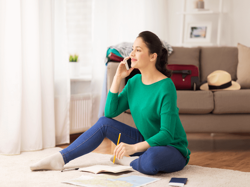 Woman booking travel on smartphone