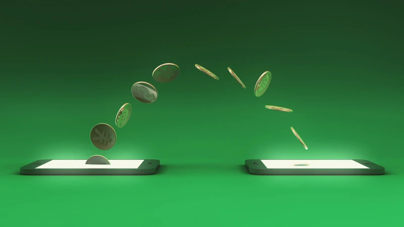 Image of two smartphones and an arc of coins in various currencies flowing between them