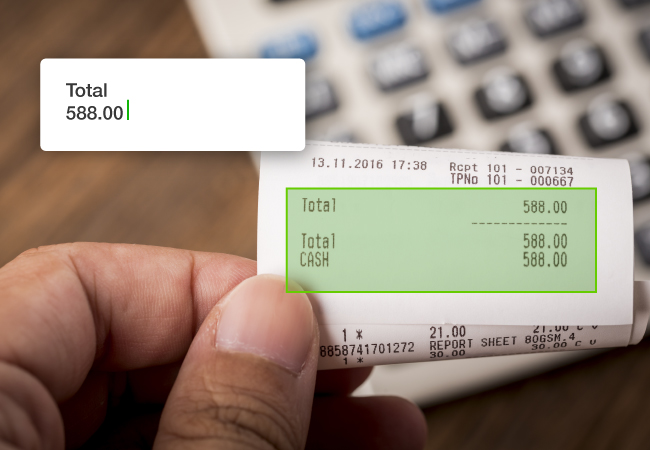 A person holds a receipt and the AI tool annotates the text to show the total number