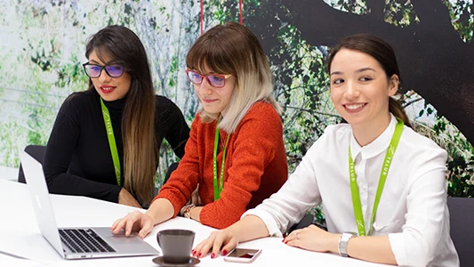 Women smiling while looking at a laptop