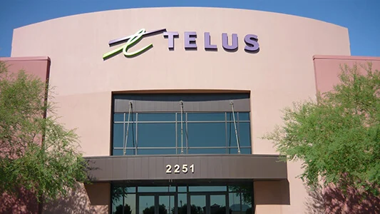 The front entrance of a building that says TELUS and then 2251 over the door