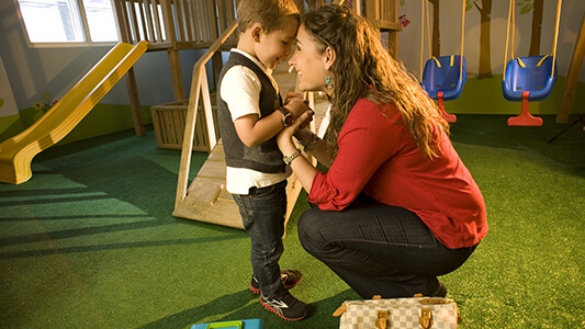 A mother with her son at an indoor playground
