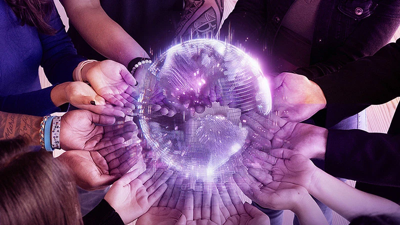 Cover image from the TELUS International 2023 Sustainability and ESG Report depicting a group of people holding their hands in a circle around an illustration of a globe