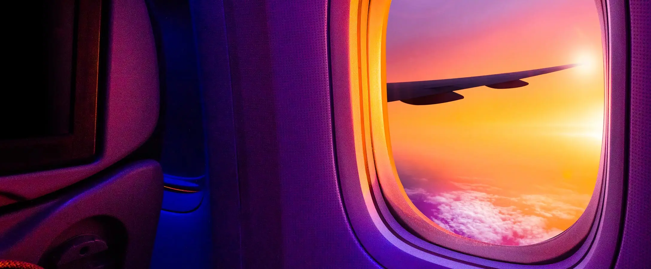 The view of a sunset from an airplane window.