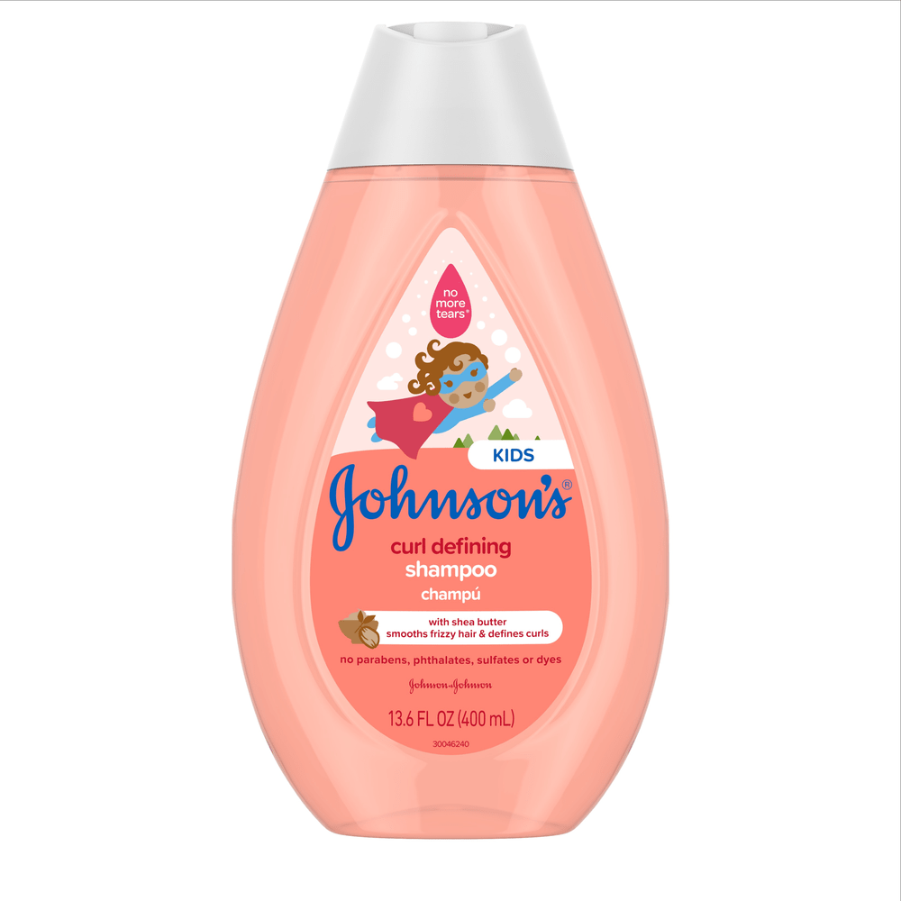 Johnsons Kids Curl Defining Shampoo bottle with shea butter, for smoothing frizzy hair and defining curls. The pink bottle has a blue and white label, featuring a cartoon girl with curly hair and a "No More Tears" logo. 13.6 FL OZ (400 mL)