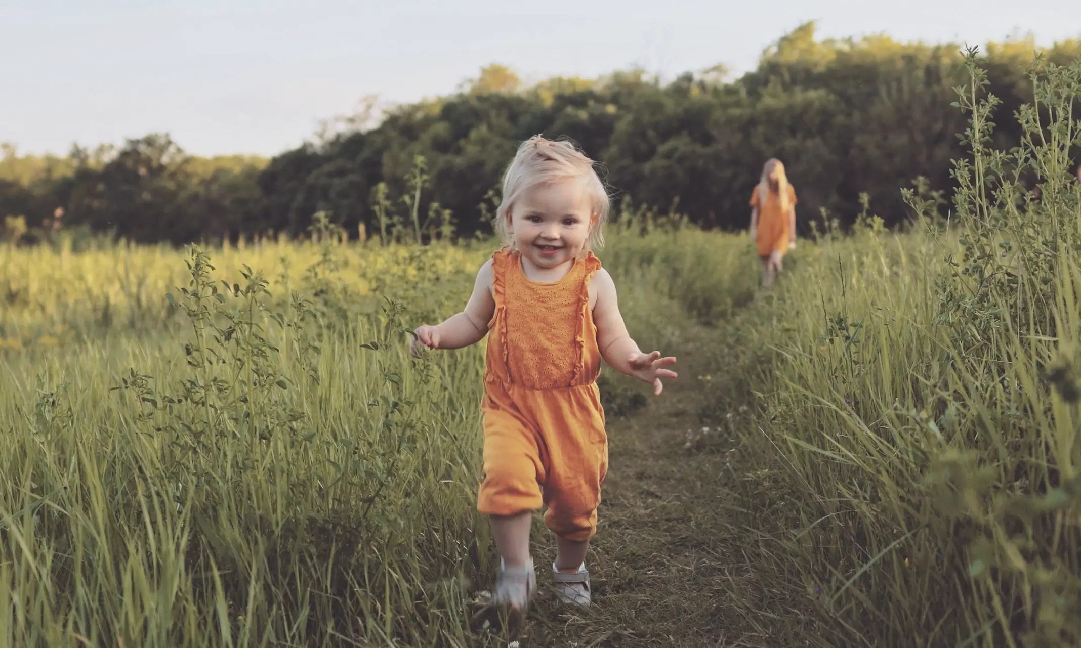 A little girl walks in nature - highlighting a healthy baby on a healthy planet.