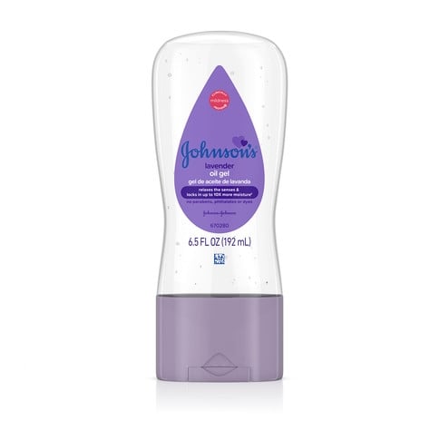 A lavender Johnson's Baby Oil Gel tube with chamomile sits upright against a white background. Text on label: "Clinically Proven Mildness," "Johnson's Baby Oil Gel," "with chamomile," and "6.5 FL OZ (192 mL)."