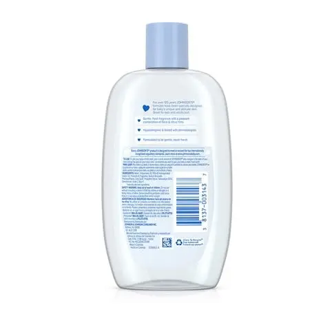 A white plastic bottle with a blue cap containing baby oil has text in English and Arabic on the back. The text instructs proper use and ingredient details.