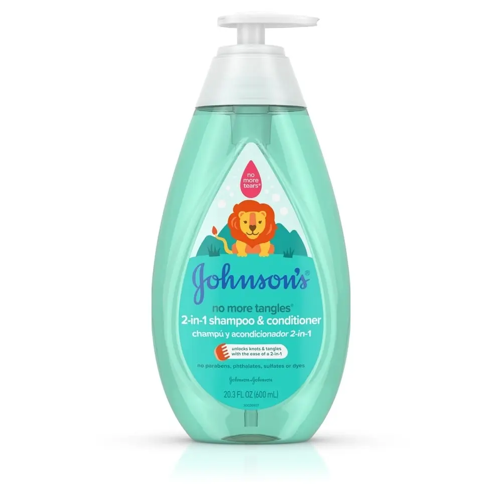 A light blue, oval-shaped bottle with a white pump dispenser labeled "Johnson's 2-in-1 Shampoo & Conditioner" features a lion illustration. It stands against a plain white background. Text says, "No more tangles."