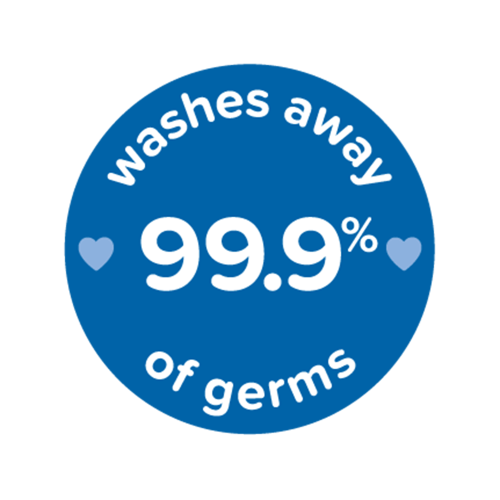 Blue circular badge with white text "washes away 99.9% of germs" and two small heart icons on either side of the text, related to Johnson's Baby products.