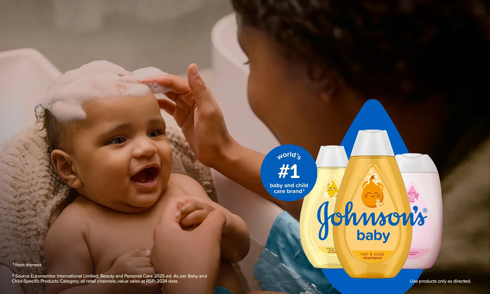 Joyful baby enjoying bath time with shampoo suds in their hair, surrounded by Johnson's baby shampoo bottles, creating a delightful and engaging bath experience.