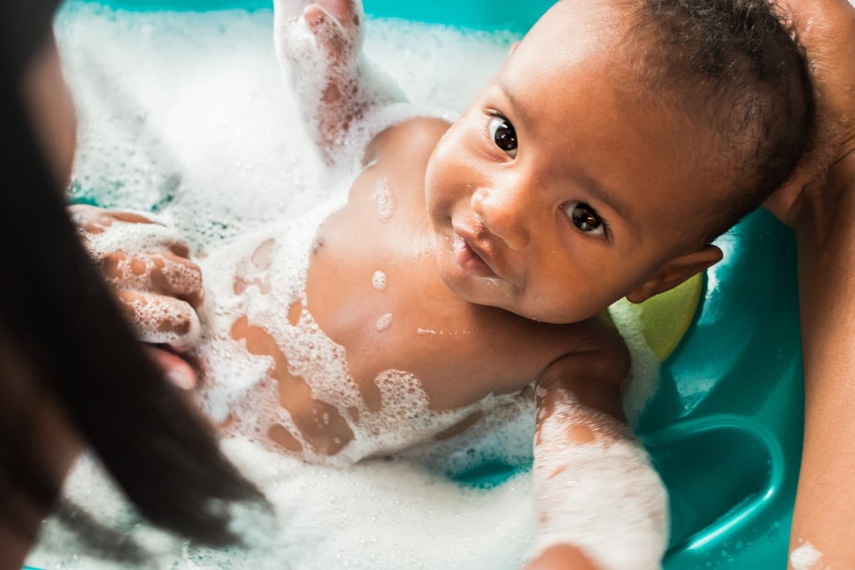 baby looking at screen while showering