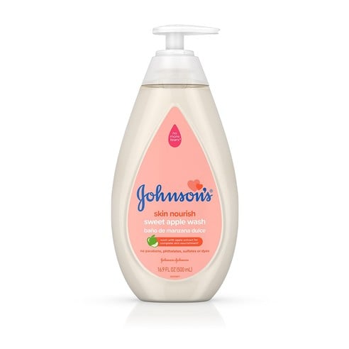 A bottle of Johnson's Skin Nourish Sweet Apple Wash with a pump dispenser. The label is pink with text that reads: "no parabens, phthalates, sulfates or dyes, hypoallergenic," and "16.9 FL OZ (500 mL)."