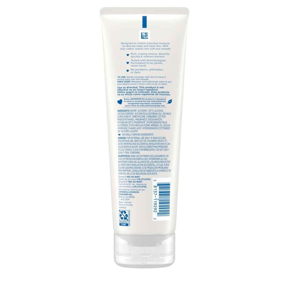 Back view of a white tube of Johnson's CottonTouch Creamy Baby Oil showing instructions and ingredients.