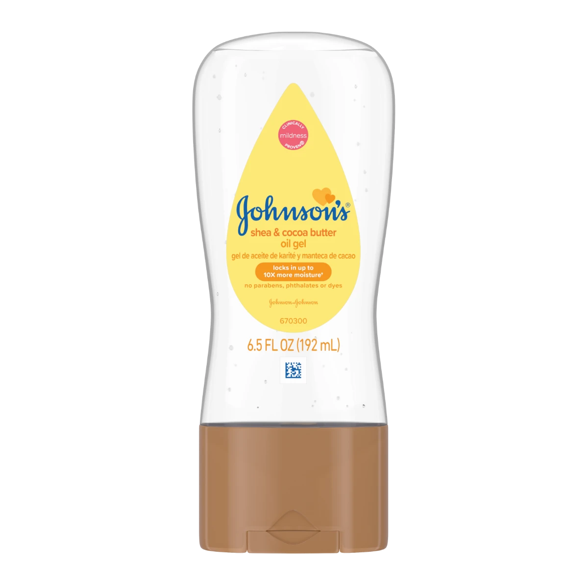 Un envase transparente etiquetado como "Aceite en gel Johnson's con manteca de karité y de cacao" con tapa marrón, que contiene 6.5 FL OZ (192 mL). Características destacadas: 24 horas de hidratación, para pieles secas. En un entorno sencillo y bien iluminado.