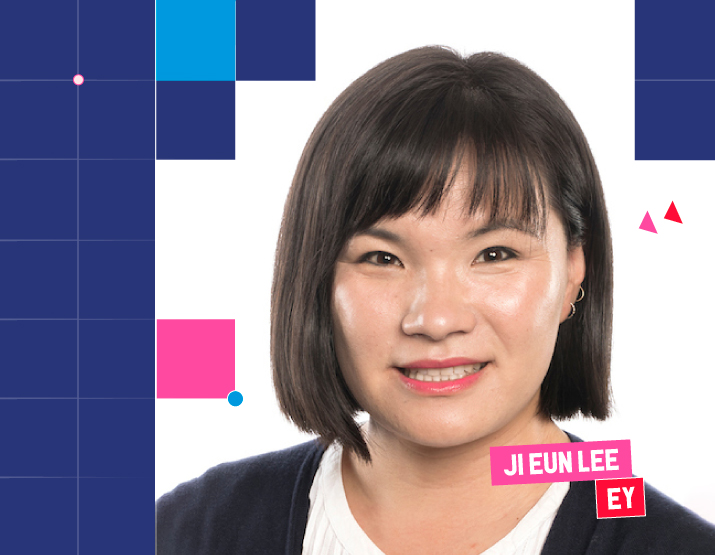 A photograph of Ji Eun Lee. Her hair is black and cut into a short bob. She is wearing a white shirt, with a black cardigan. She is wearing red lipstick and smiling direct to camera. Square Graphic elements border the image, and across the bottom right of the image, her name is included in block letters against a pink background. Underneath her name, EY is written in white block letters against a red background.