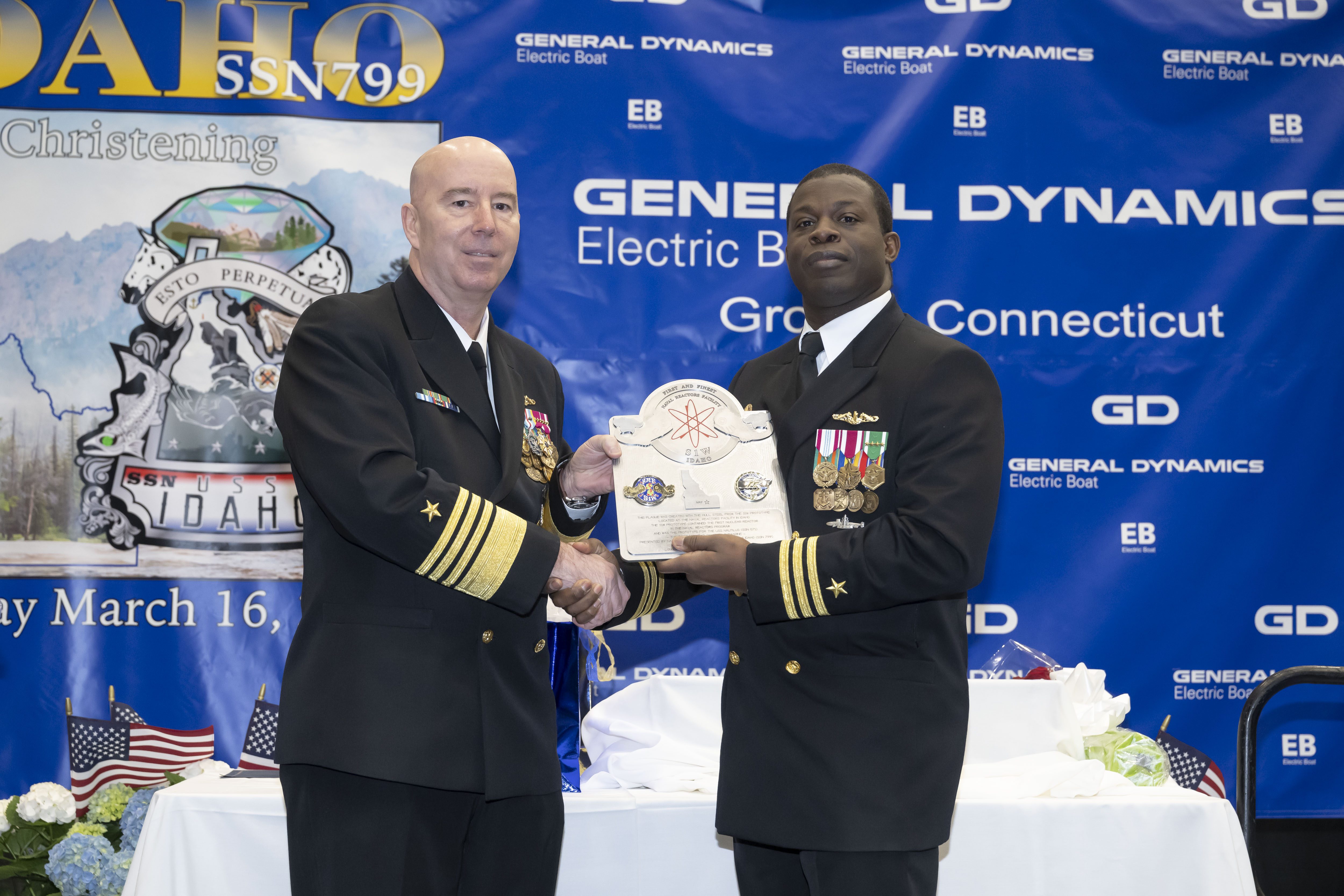 Director Naval Reactors ADM William Houston presents r CDR Randall with a special Nuclear Reactors plaque