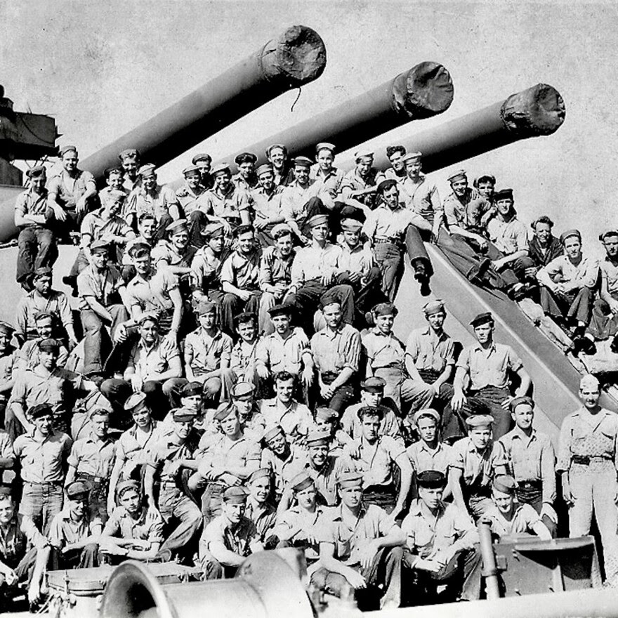 Sailors aboard USS Idaho battleship surrounding 14