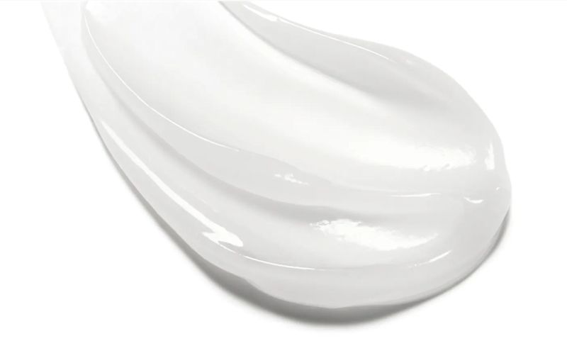 A smooth, thick white cream is swatched across a white surface.