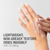 A woman samples face moisturizer on her hand