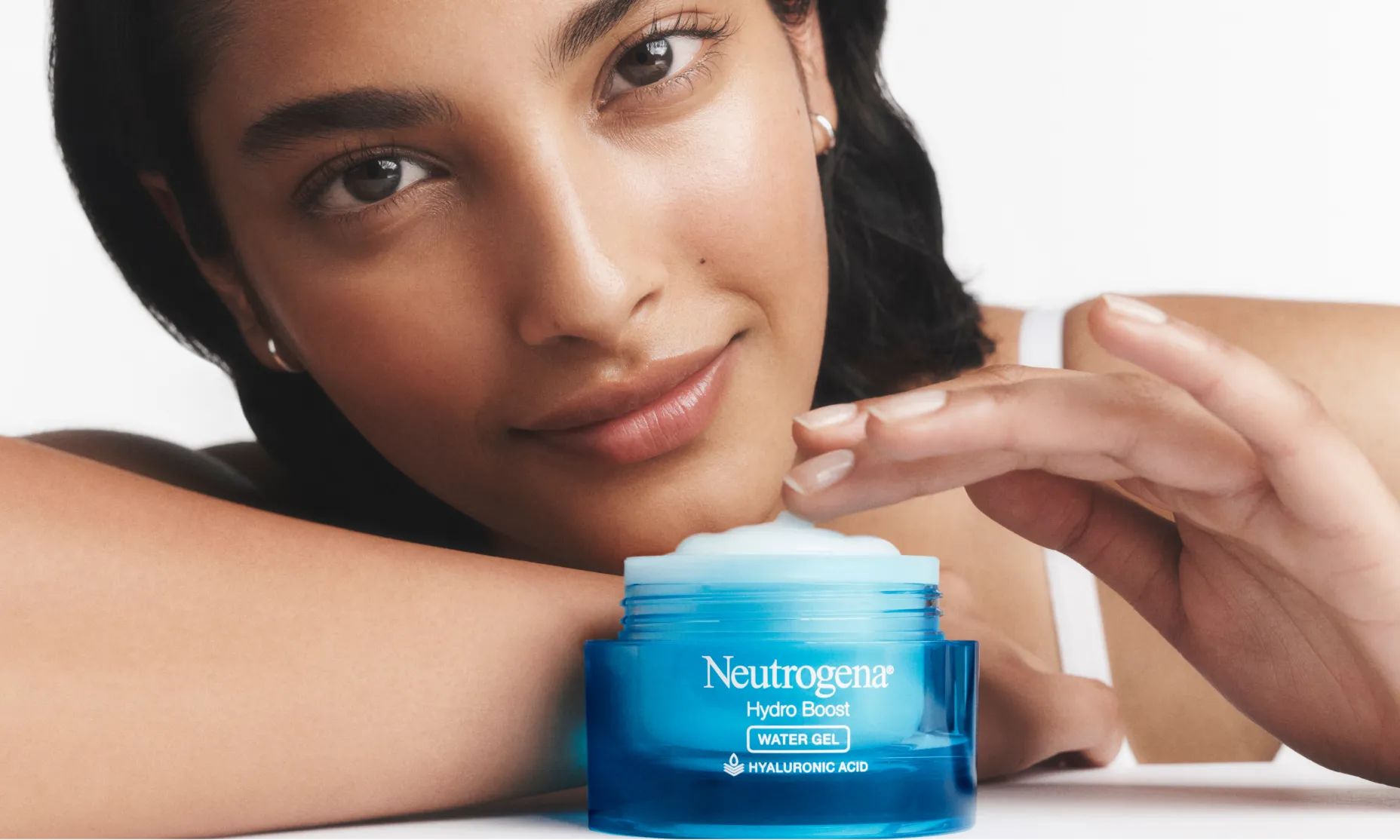Woman applying Hydro Boost Gel Cream Moisturizer with an open jar