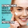 Young woman applying Neutrogena® Ultra Gentle Moisturizer SPF 30 on her face and smiling