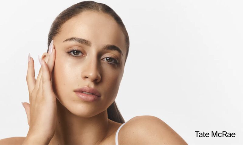 Tate McRae with clear skin applying Neutrogena® Hydro Boost products to face