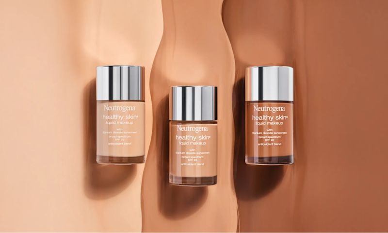 Neutrogena® Healthy Skin Liquid Makeup Broad Spectrum SPF 20 bottles of different shades on top of liquid texture swatches