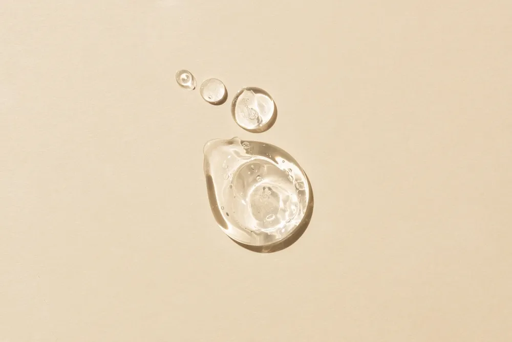 A pipette on a yellow glass surface.