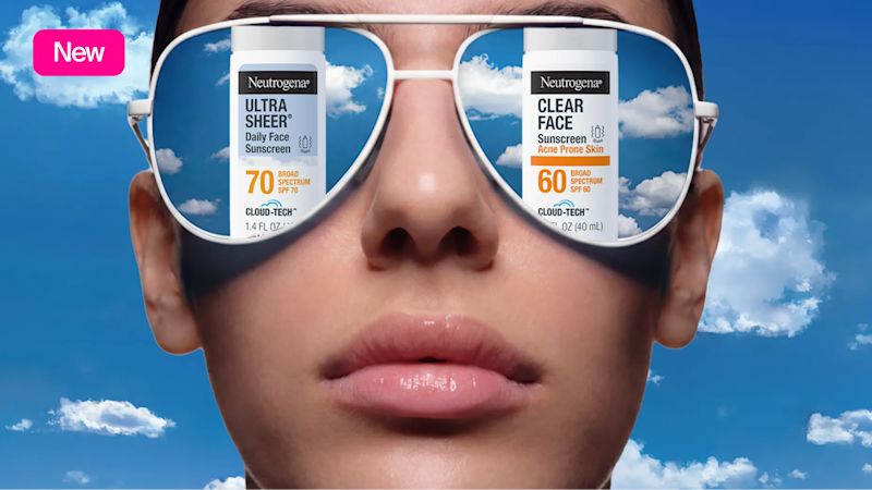 Woman wearing sunglasses reflecting the sky packaging of Neutrogena® Cloud Tech™ Bemotrinzinol BEMT sunscreen