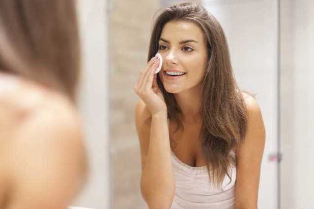 Woman using cotton pad for application