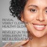 A woman smiling with the text 'reveal visibly clearer, healthy glow'