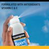 Hand spraying Neutrogena® Sport SPF 70 sunscreen with antioxidants Vitamin C & E