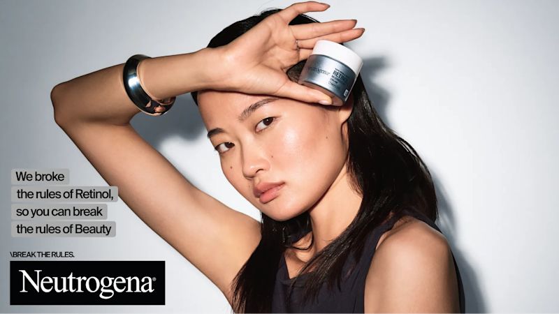 Woman holding a jar of Neutrogena® Rapid Wrinkle Repair® Retinol Regenerating Cream Fragrance Free and the text "We broke the rules of retinol so you can break the rules of beauty"