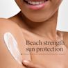 Woman applying Neutrogena® Beach Defense® Water + Sun Protection Sunscreen Stick to skin. Beach strength sun protection
