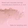 Scattered mineral powder with vitamins A, C, E on pink background safe for sensitive skin