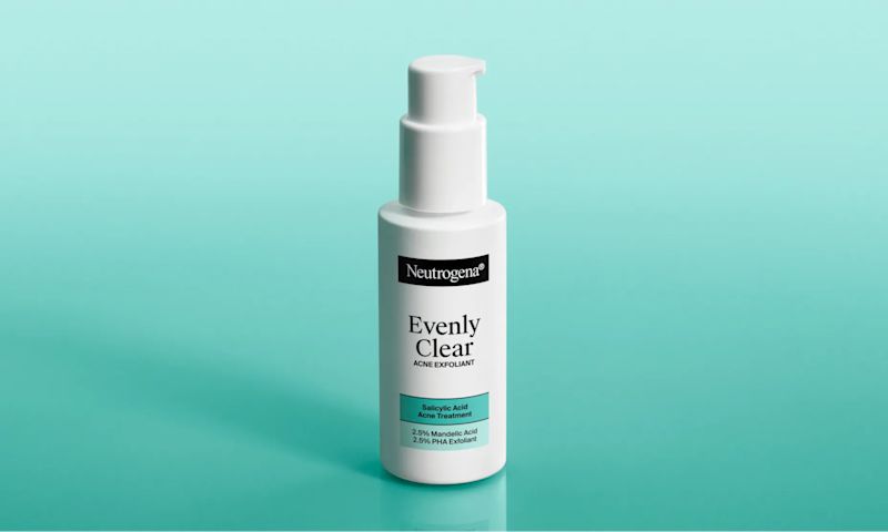 Neutrogena® Evenly Clear™ Acne Exfoliant packaging against a teal background