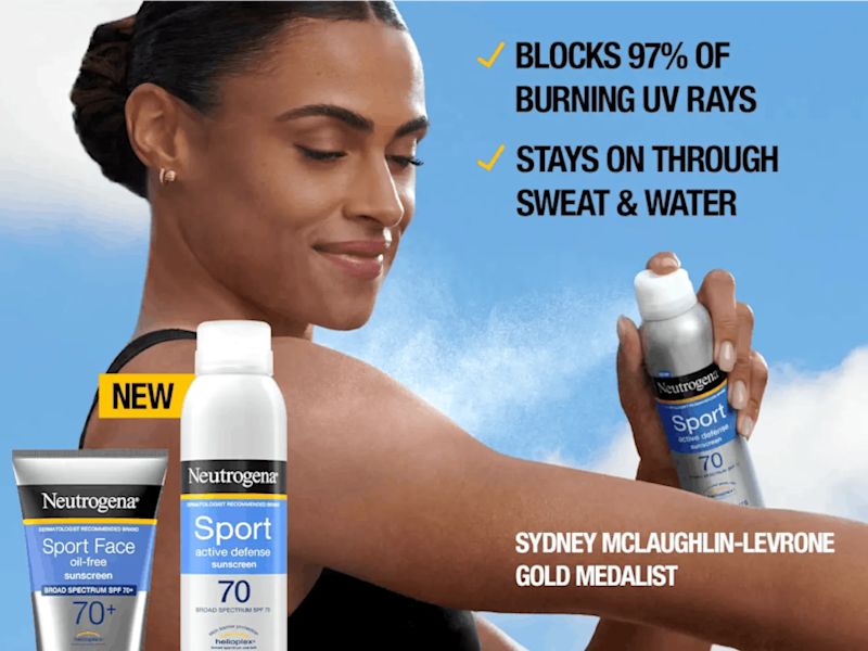 A photo of Olympian Sydney McLaughlin-Levrone holding and spraying Neutrogena Sport Active Defense sunscreen