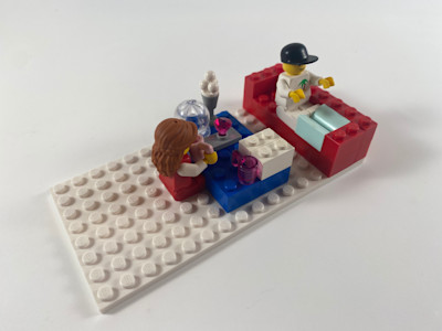 Photograph of LEGO creation "Brother is reading"
