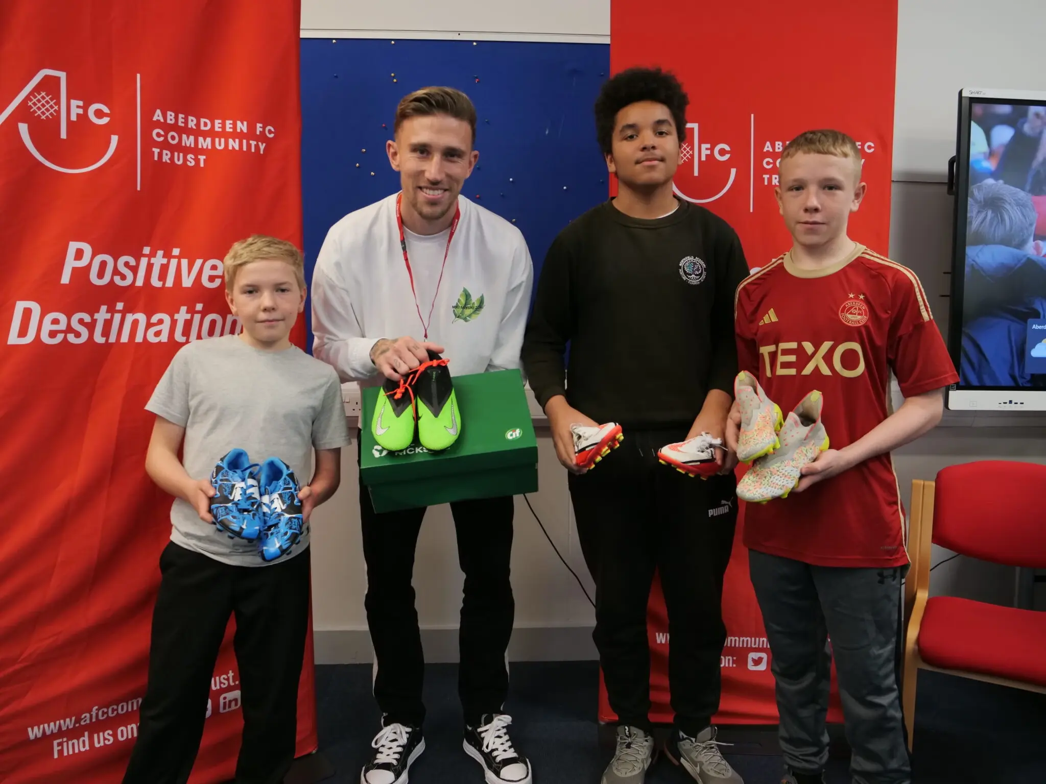 Re-furbished football boots by CIF delivered to Northfield Academy by Aberdeen FC’s Angus MacDonald image