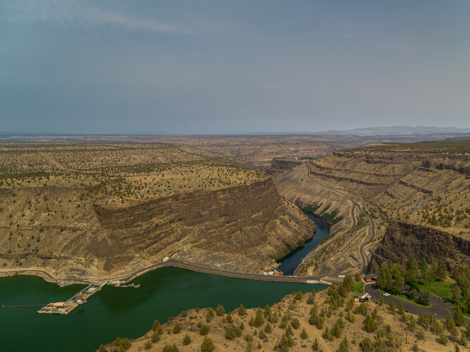 view of mountains, water and trees at round butte dam