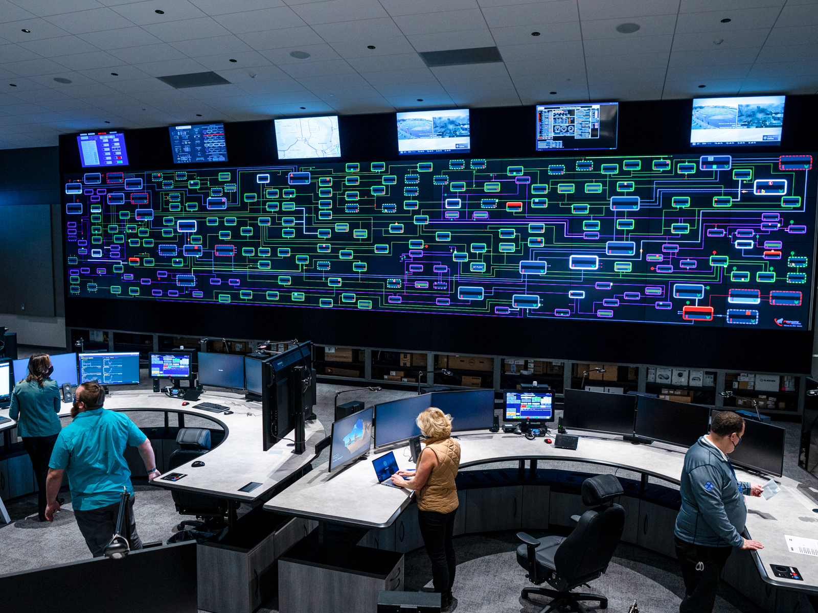 Desks and large screens in the Integrated operations center IOC