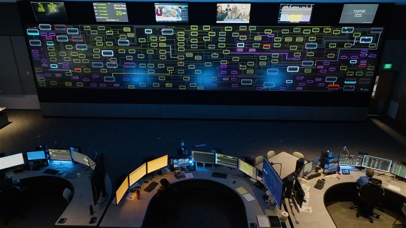 Someone working on multiple screens in the Integrated operations center IOC