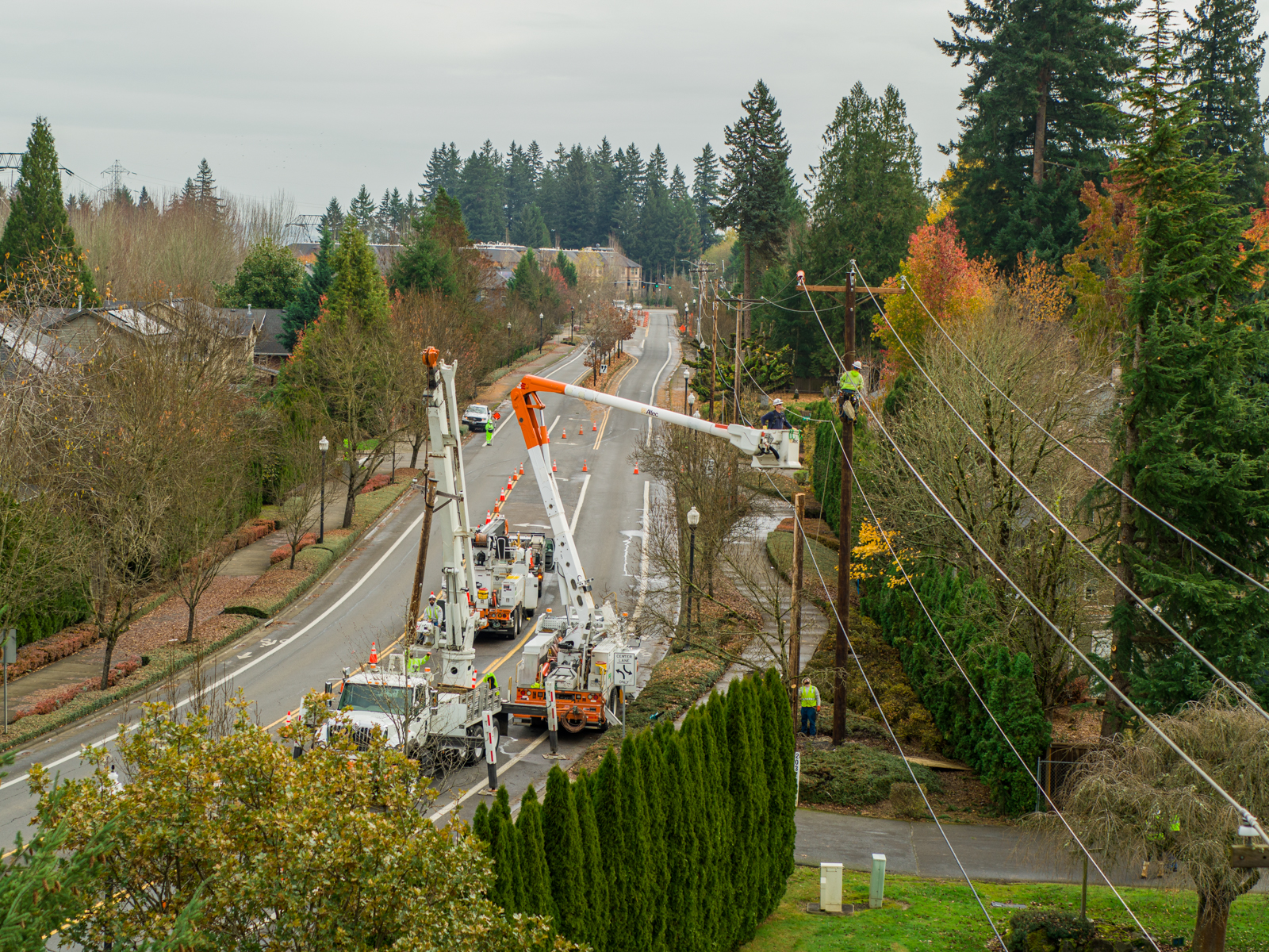 Two trucks of PGE line crews change out a power pole in Sherwood, Ore.