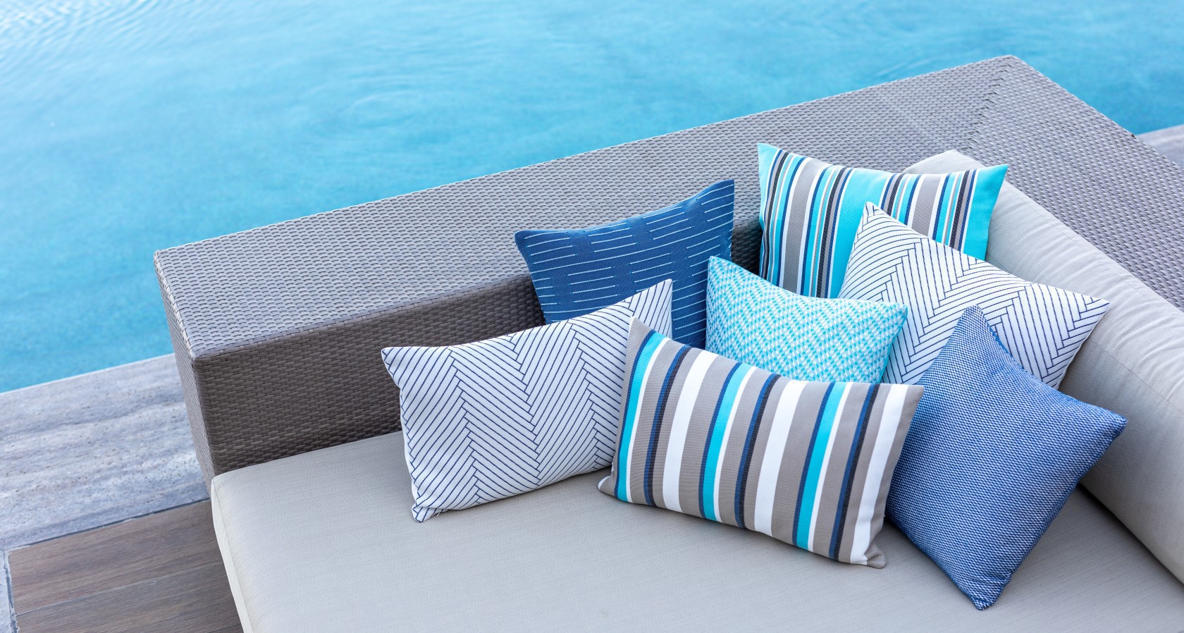 couch with colorful cushions by the sea