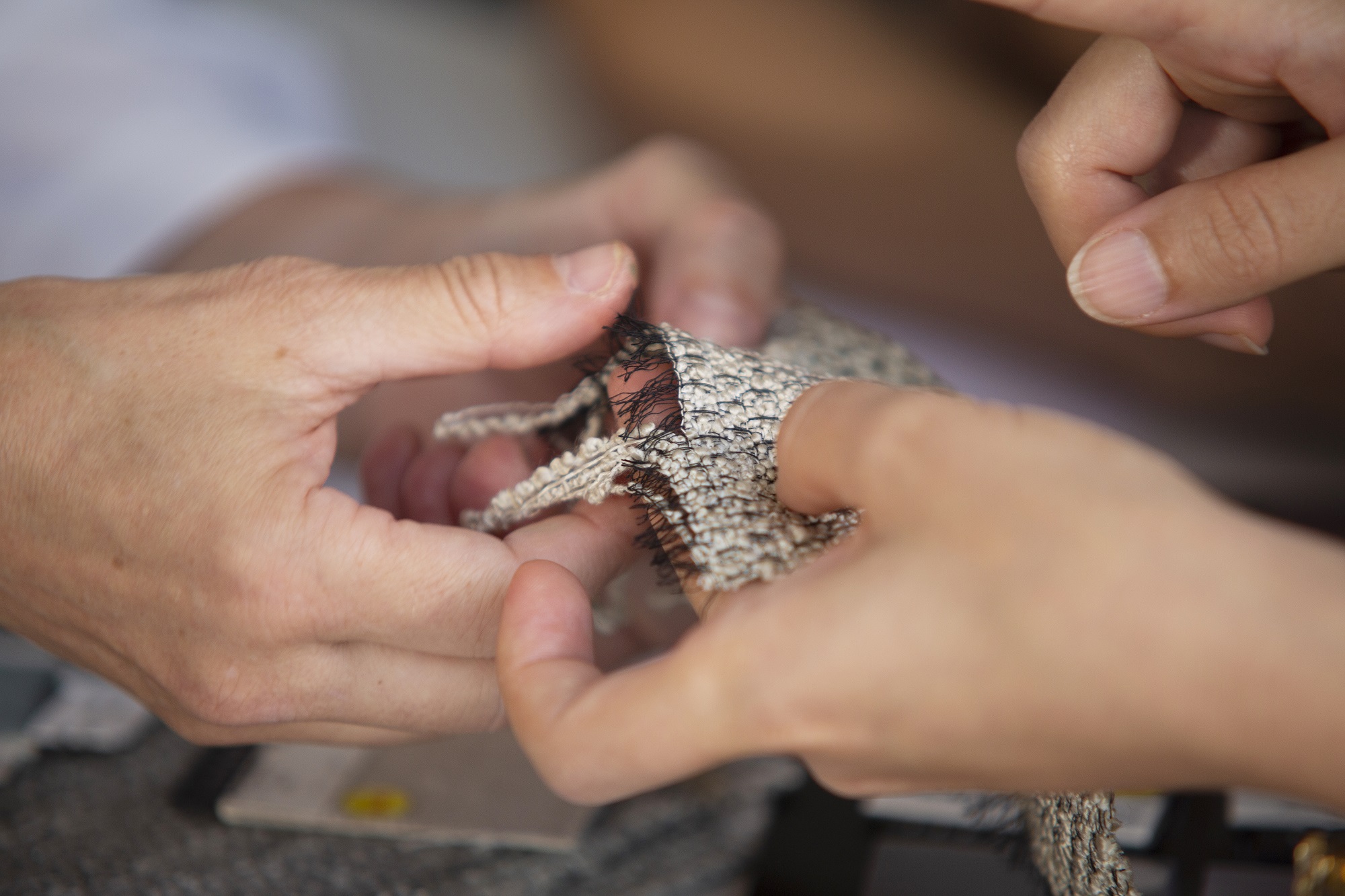 hands touching fabric
