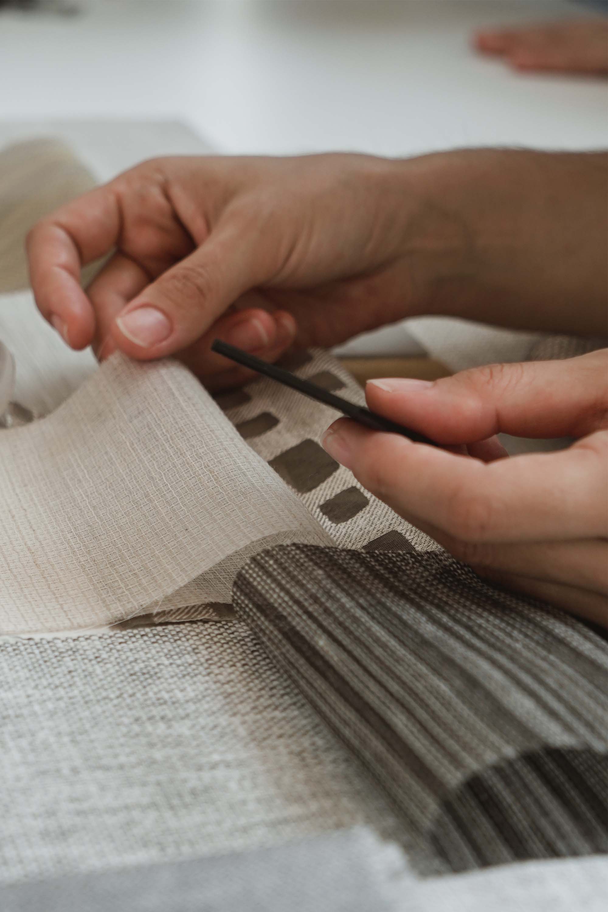 hands touching fabric swatches